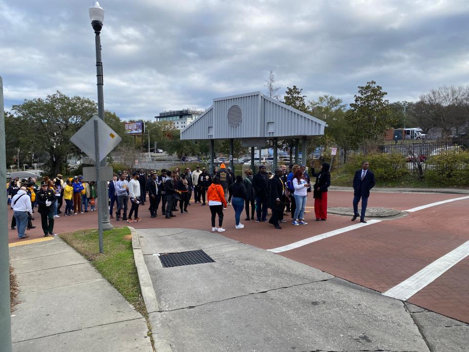 Members of the NAACP Tallahassee chapter line up, with local leaders behind them, as they prepare to lead their symbolic march to the capitol as part of their MLK day event.