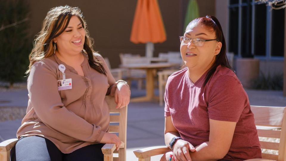 Photo of Native Health Navigator Shayna Grandbois-Herrera meeting with breast cancer patient Amy.