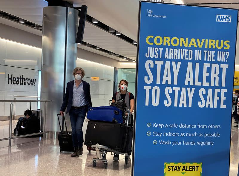 Passengers arrive at Heathrow Airport, as Britain launches its 14-day quarantine for international arrivals, following the outbreak of the coronavirus disease (COVID-19), London, Britain