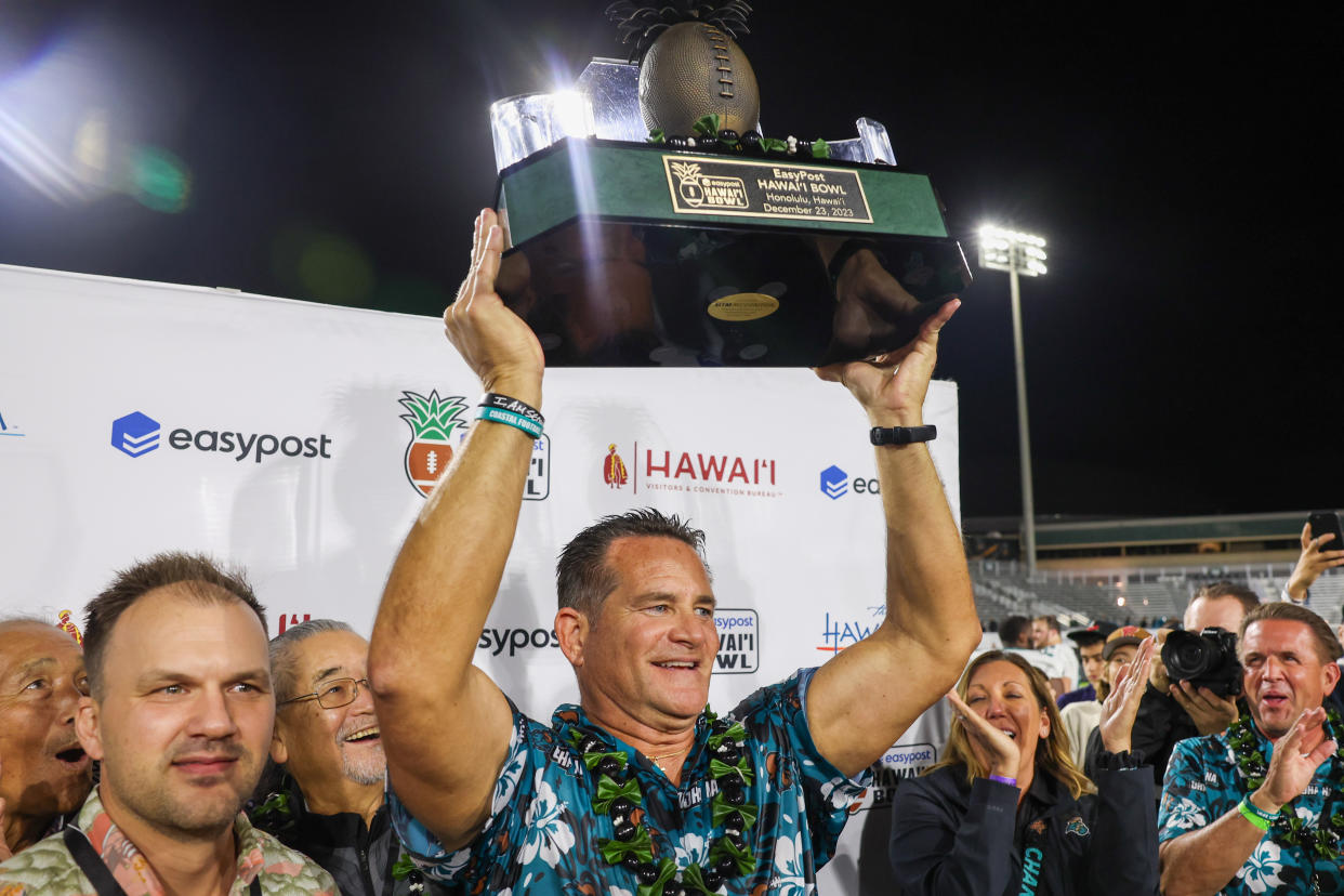 HONOLULU, HAWAII - DECEMBER 23: Head coach Tim Beck of the Coastal Carolina Chanticleers hoists the championship trophy after winning the Hawaii Bowl at Clarence T.C. Ching Athletics Complex against the San Jose State Spartans on December 23, 2023 in Honolulu, Hawaii. (Photo by Darryl Oumi/Getty Images)