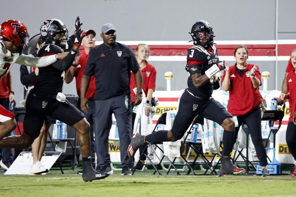 North Carolina State's Aydan White runs back his interception for a touchdown during the first half of an NCAA college football game against Texas Tech in Raleigh, N.C., Saturday, Sept. 17, 2022. (AP Photo/Karl B DeBlaker)