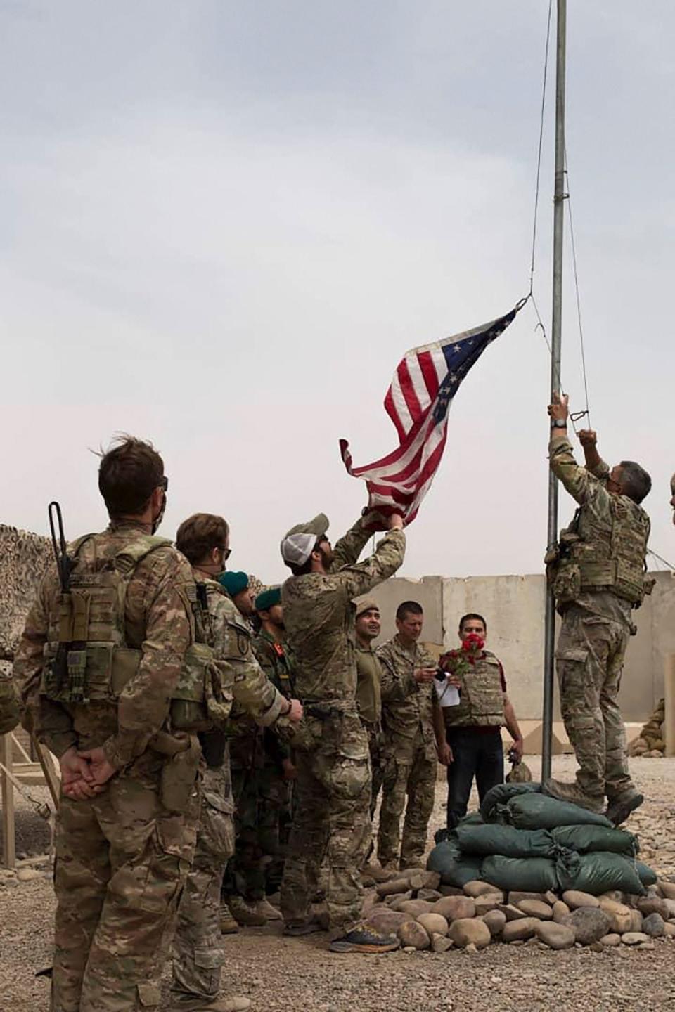 U.S. soldiers lowering the American flag during a handover ceremony in Helmand province to the Afghan National Army on May 2, 2021.