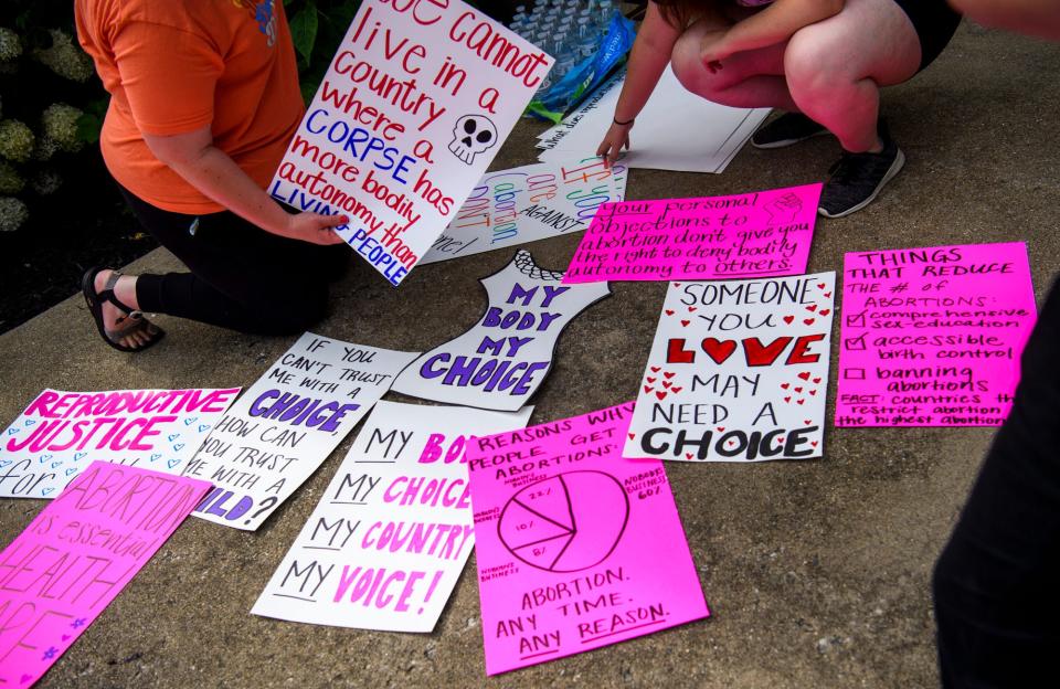 Signs wait to be picked up during a protest of the overturning of the Roe v. Wade decision by the Supreme Court at the Monroe County Courthouse on June 24, 2022.