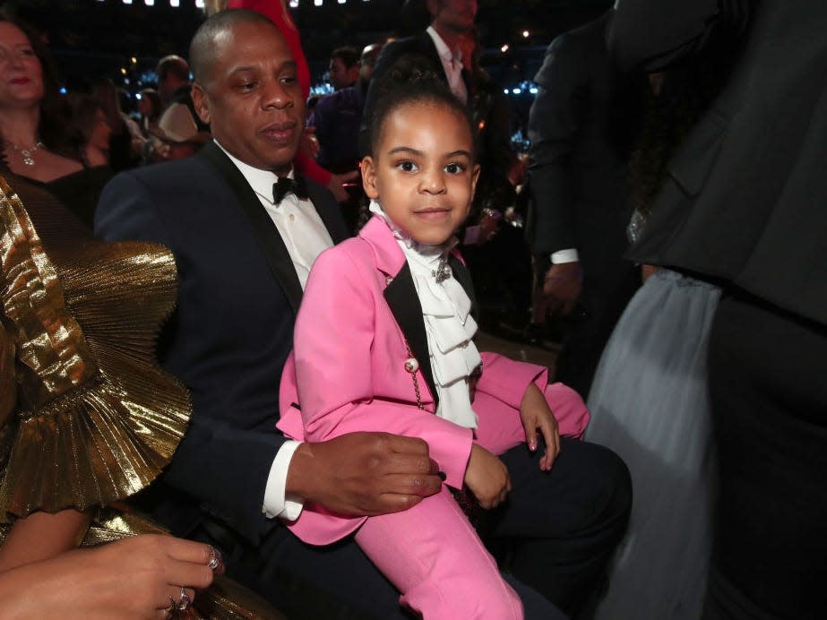 Blue Ivy Carter sits on her dad Jay-Z's lap at the 2017 Grammy Awards.