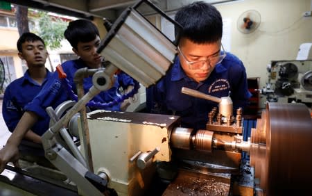 Students practise at a lab of an industrial vocational training college in Hanoi