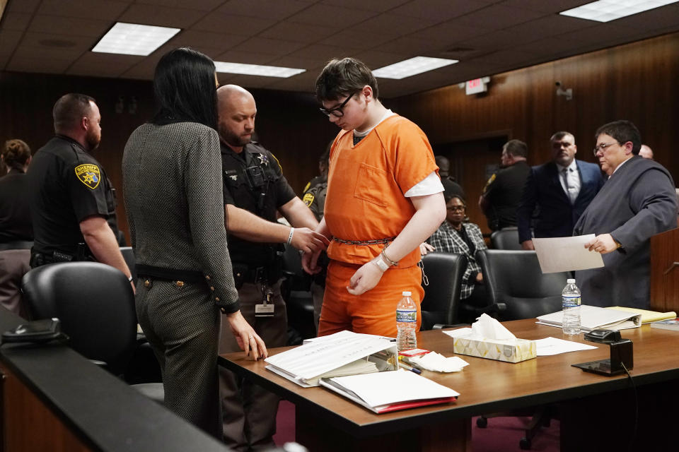 Ethan Crumbly is escorted by sheriff deputies after being sentenced, Friday, Dec. 8, 2023, in Pontiac, Mich. Crumbly sentenced to life in prison for killing four students, wounding more and terrorizing Michigan's Oxford High School in 2021. A judge Friday rejected pleas for a shorter sentence and ensured that Crumbley, 17, will not get an opportunity for parole. (AP Photo/Carlos Osorio)