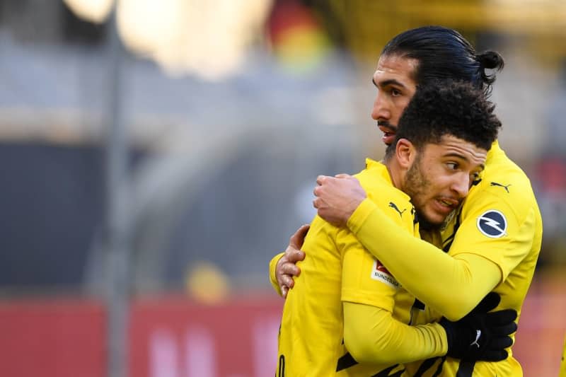 Then Borussia Dortmund's Jadon Sancho (L) celebrates scoring his side's first goal with teammate Emre Can during the German Bundesliga soccer match between Borussia Dortmund and TSG 1899 Hoffenheim at Signal Iduna Park. Borussia Dortmund captain Emre Can would be "extremely" happy to see his former team-mate Jadon Sancho return to the club. Marius Becker/dpa