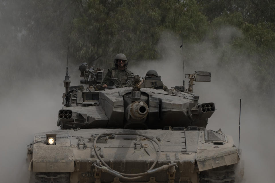 Israeli soldiers move on the top of a tank near the Israeli-Gaza border, as seen from southern Israel, Thursday, April 25, 2024. (AP Photo/Leo Correa)