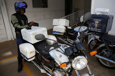 A motorcycle-riding paramedic prepares to depart from the Avenue hospital in Nairobi, Kenya February 1, 2019. Picture taken February 1, 2019. REUTERS/Baz Ratner