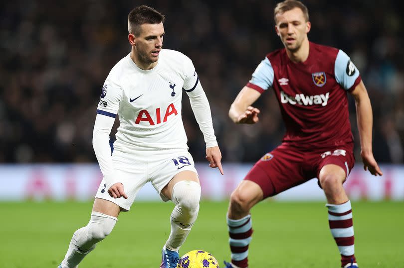Giovani Lo Celso of Tottenham Hotspur runs with the ball while under pressure from Tomas Soucek of West Ham United