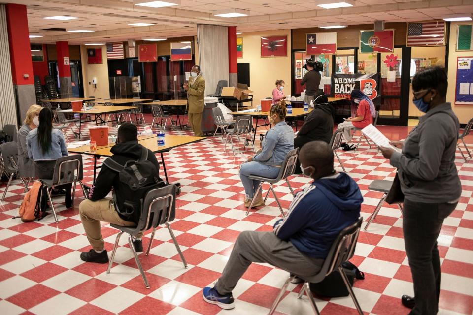 Students and family members wait to be called to receive their first dose of the Pfizer COVID-19 vaccine during the vaccination clinic in the red cafeteria at Brockton High School on Thursday, May 6, 2021.