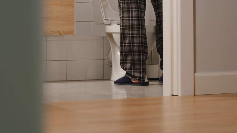 shot of a man's feet while he's peeing