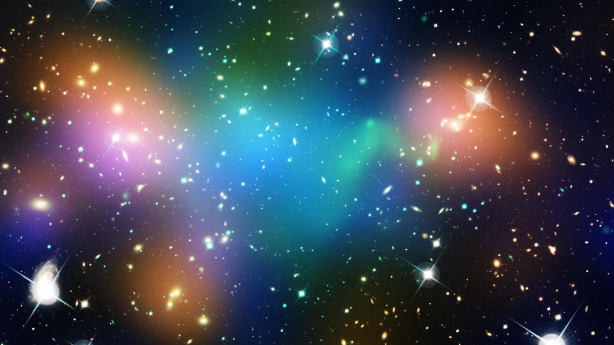  This composite image shows the distribution of dark matter, galaxies, and hot gas in the core of the merging galaxy cluster Abell 520, formed from a violent collision of massive galaxy clusters. 