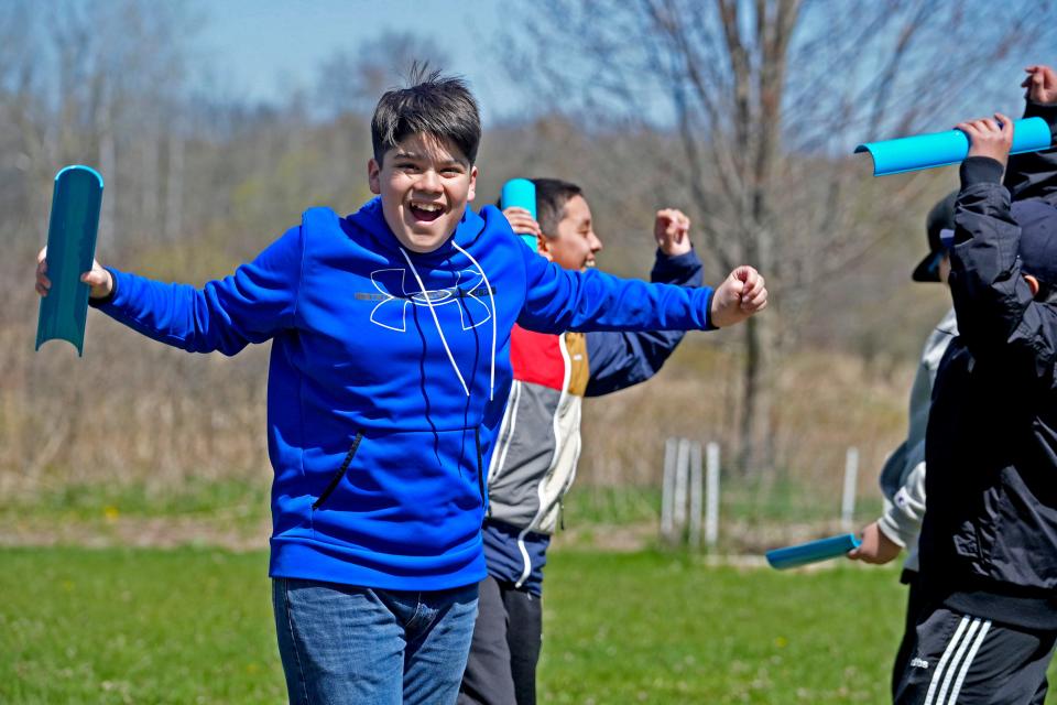 Santiago Iniguez, a student at Notre Dame Middle School, celebrates after his team wins a team-building game this spring at the Catholic Ecology Center in Neosho. The 60-acre center saw more than 6,000 visitors last year.