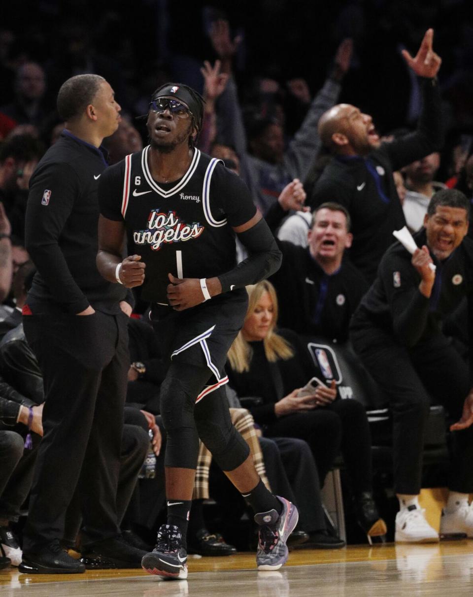 The Clippers bench reacts after guard Reggie Jackson sinks a three-point shot.