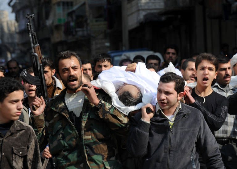 Syrians carry a body of a fighter during his funeral in the northeastern city of Aleppo on February 15, 2013. Syrian rebels captured a military airbase in the north and geared up for a major battle against loyalists as the opposition said it refuses to accept President Bashar al-Assad in talks on the 23-month conflict