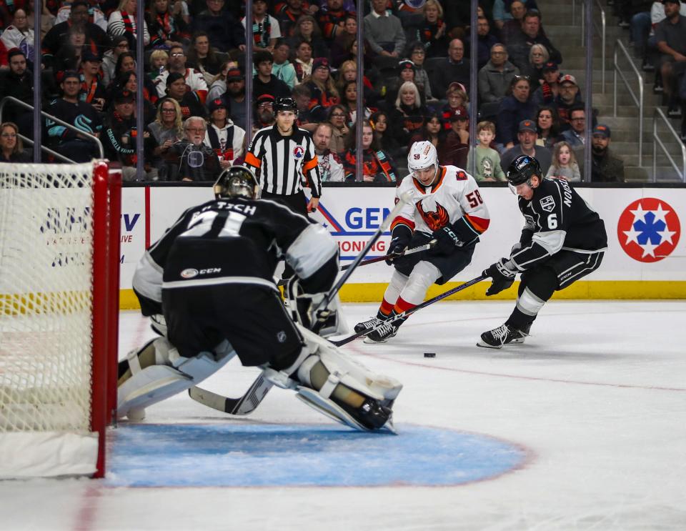 Coachella Valley defenseman Connor Carrick (58) looks to take a shot on Ontario goaltender David Rittich (31) as defenseman Kim Nousiainen (6) gets involved to help block during the first period of their game at Acrisure Arena in Palm Desert, Calif., Tuesday, Nov. 21, 2023.