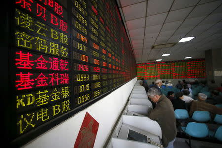 Investors look at computer screens showing stock information at a brokerage house in Shanghai, China, April 21, 2016. REUTERS/Aly Song