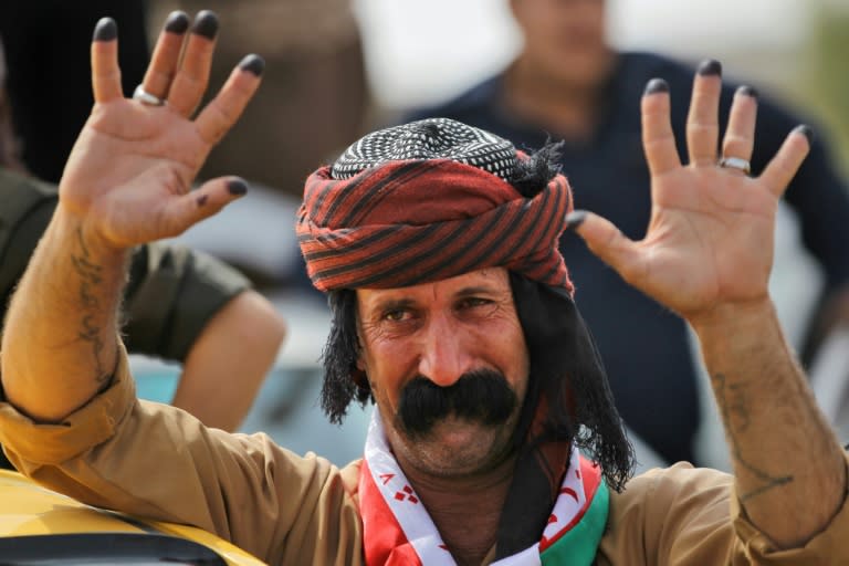 An Iraqi Kurdish man shows his ten ink-stained fingers after casting his vote in the Kurdish independence referendum in the city of Kirkuk