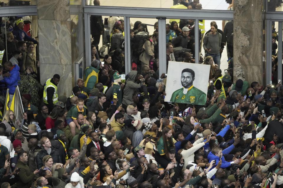 Fans welcome South Africa' Springbok team as they arrive at O.R Tambo's international airport in Johannesburg, South Africa, Tuesday Oct. 31, 2023, after the Rugby World Cup. (AP Photo/Jerome Delay)