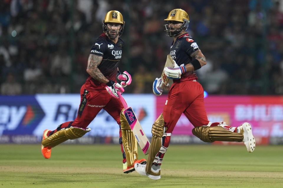 Royal Challengers Bangalore's captain Faf du Plessis, left, and Virat Kohli run between the wickets to score during the Indian Premier League cricket match between Royal Challengers Bangalore and Mumbai Indians in Bengaluru, India, Sunday, April 2, 2023. (AP Photo/Aijaz Rahi)