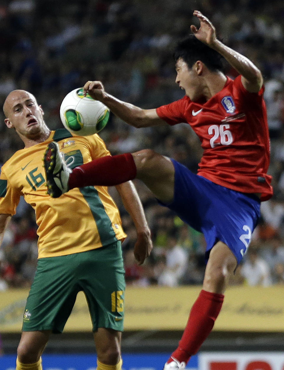 FILE - In this July 20, 2013 file photo, South Korea's Lee Seung-gi, right, fights for the ball against Australia's Ruben A. Zadkovic during their East Asian Cup soccer match at Seoul World Cup stadium in Seoul, South Korea. The second round of the Asian Champions League takes on extra emphasis for some World Cup hopefuls this week, with South Korea’s Hong Myong-bo among the national team coaches carefully watching the continental club competition before announcing his squad for Brazil 2014. (AP Photo/Lee Jin-man, File)