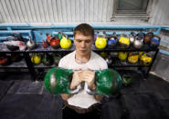 A man lifts weights at a sports complex at the Aksu Ferroalloys Plant in the town of Aksu, north-eastern Kazakhstan, February 22, 2018. REUTERS/Shamil Zhumatov/Files