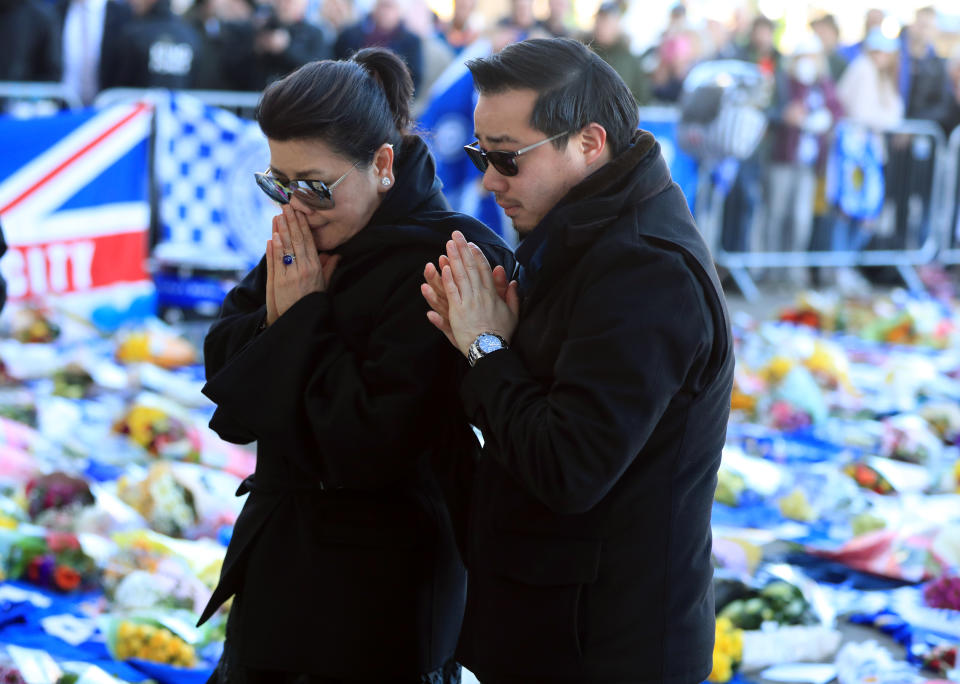 Aiyawatt Srivaddhanaprabha lays a wreath in memory of his father with his mother Aimon. Mike Egerton/PA Wire