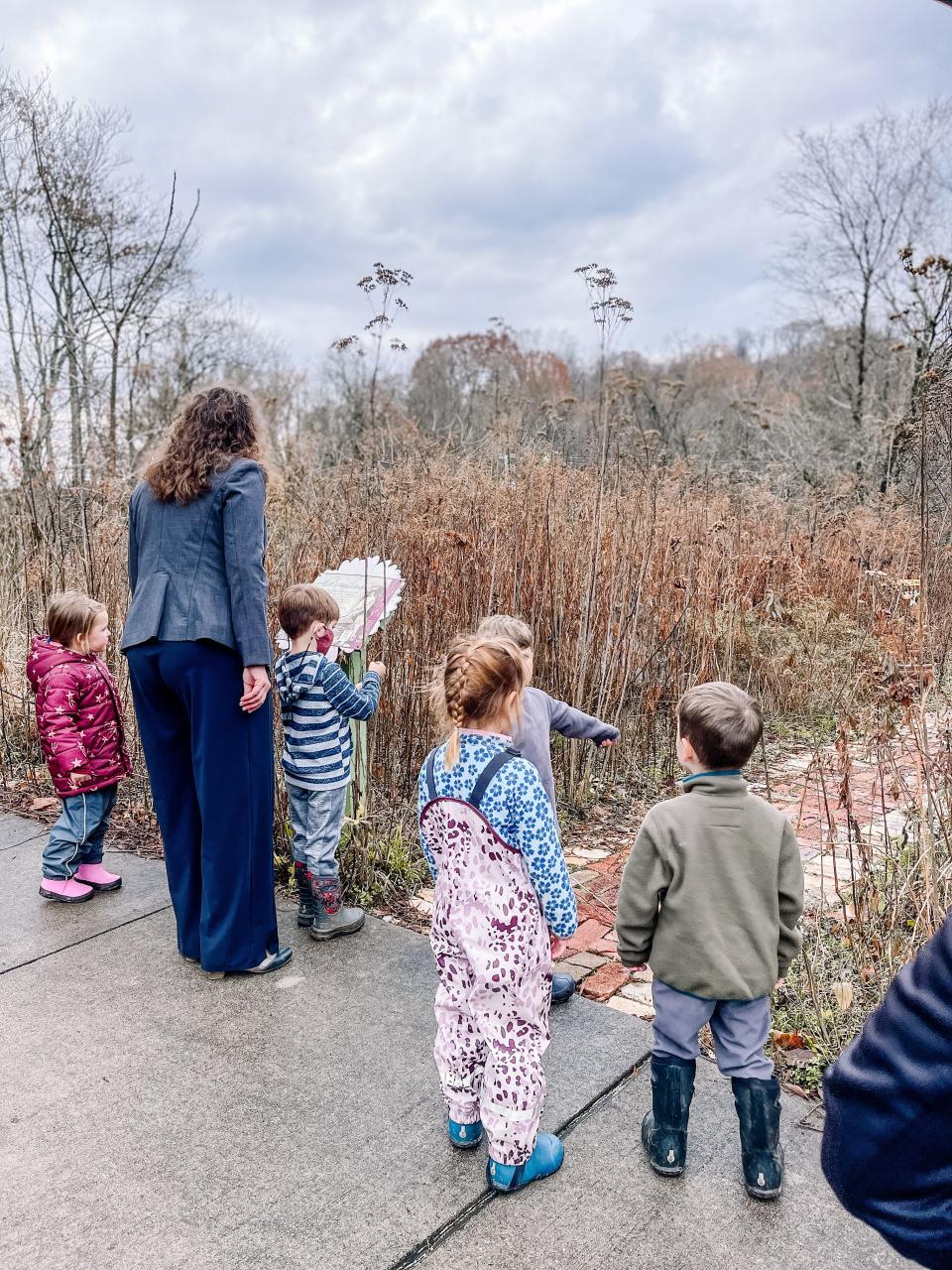 Mayor Indya Kincannon reads pages along the Public Library Storybook trail at Ijams Nature Center features “Run Wild” by David Covell, a story celebrating nature and a carefree spirit. Nov. 30, 2022.