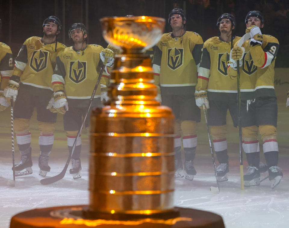 LAS VEGAS, NEVADA - OCTOBER 10: The Stanley Cup is displayed as (L-R) Paul Cotter #43, Jonathan Marchessault #81, Brayden McNabb #3, Brett Howden #21 and Jack Eichel #9 of the Vegas Golden Knights watch the 2023 Stanley Cup championship banner being raised during a ceremony before the team's home opener against the Seattle Kraken at T-Mobile Arena on October 10, 2023 in Las Vegas, Nevada. The Golden Knights defeated the Kraken 4-1. (Photo by Ethan Miller/Getty Images)