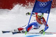 France's Alexis Pinturault clears a gate during the first run of the men's alpine skiing giant slalom event at the 2014 Sochi Winter Olympics at the Rosa Khutor Alpine Center February 19, 2014. REUTERS/Dominic Ebenbichler (RUSSIA - Tags: SPORT SKIING OLYMPICS)