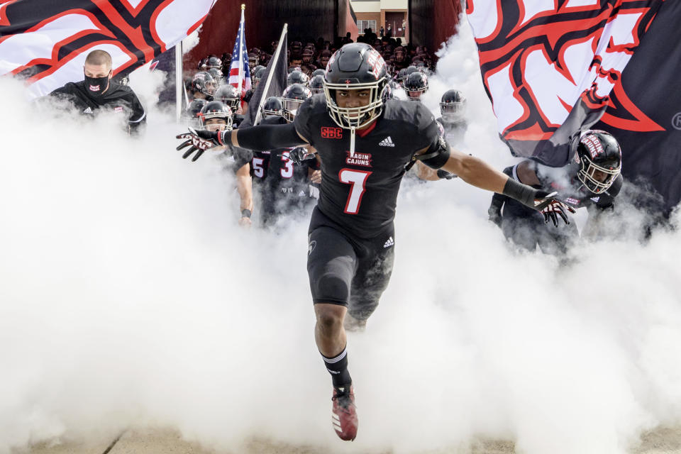 Louisiana-Lafayette linebacker Ferrod Gardner (7) enters the field with Louisiana-Lafayette head coach Billy Napier before an NCAA college football game against South Alabama in Lafayette, La., Saturday, Nov. 14, 2020. (AP Photo/Matthew Hinton)