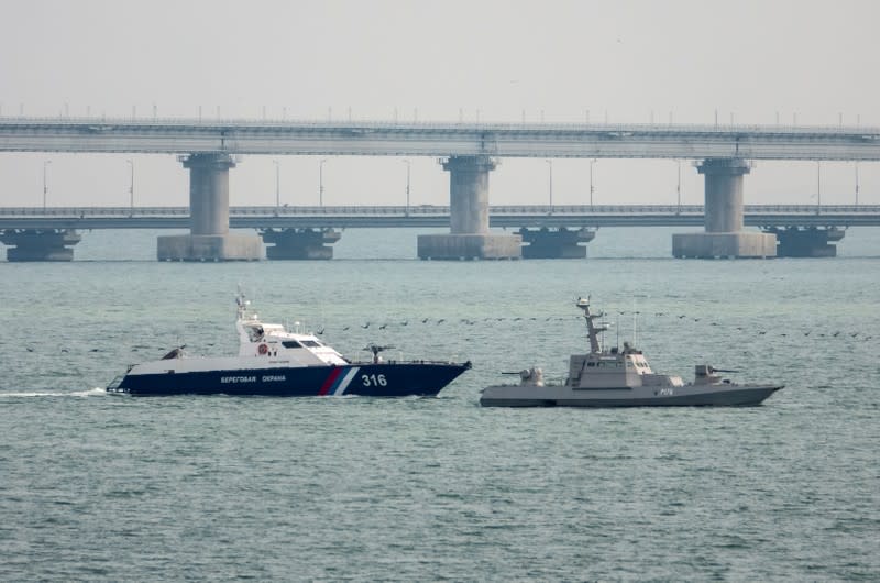 Seized Ukrainian naval ships are towed by Russia's Coast Guard vessels out of the port in Kerch