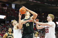 Wisconsin's Tyler Wahl (5) fouls Purdue's Zach Edey (15) during the first half of an NCAA college basketball game Sunday, Feb. 4, 2024, in Madison, Wis. At right is Wisconsin's Steven Crowl (22). (AP Photo/Andy Manis)
