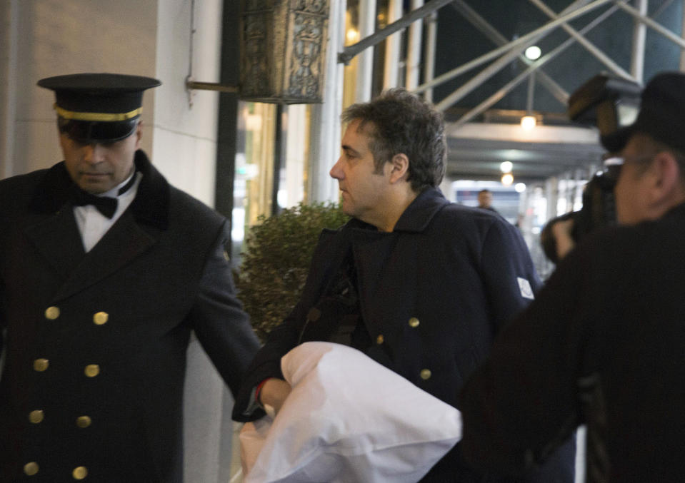 ADDS THAT COHEN'S LEFT ARM IS IN A SLING - Michael Cohen arrives at his home in New York with his left arm in a sling supported by a pillow Friday, Jan. 18, 2019. Democrats are vowing to investigate whether President Donald Trump directed Cohen, his personal attorney, to lie to Congress about a Moscow real estate project, calling that possibility a "concern of the greatest magnitude." (AP Photo/Kevin Hagen)