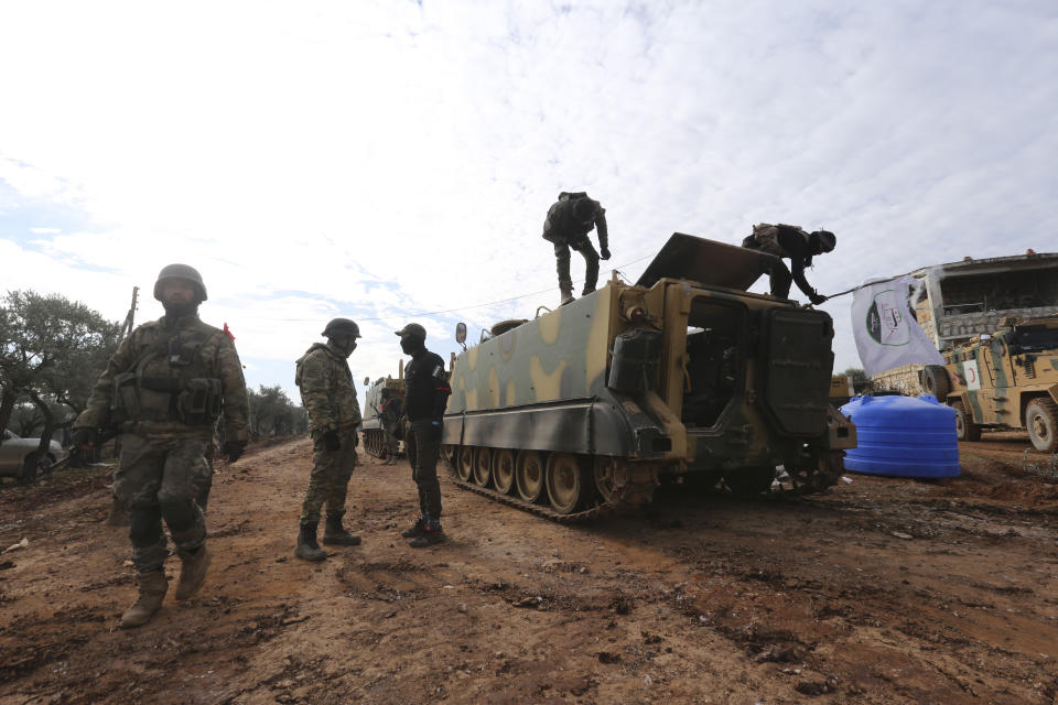 Turkish backed Syrian fighters prepare to go to frontline in Idlib province, Syria. Tuesday, Feb. 11, 2020. The fighting on Tuesday concentrated near the village of Nairab as rebels, with the backing of Turkish artillery, tried to retake the village that they lost last week, according to opposition activists. (AP Photo/Ghaith Alsayed)