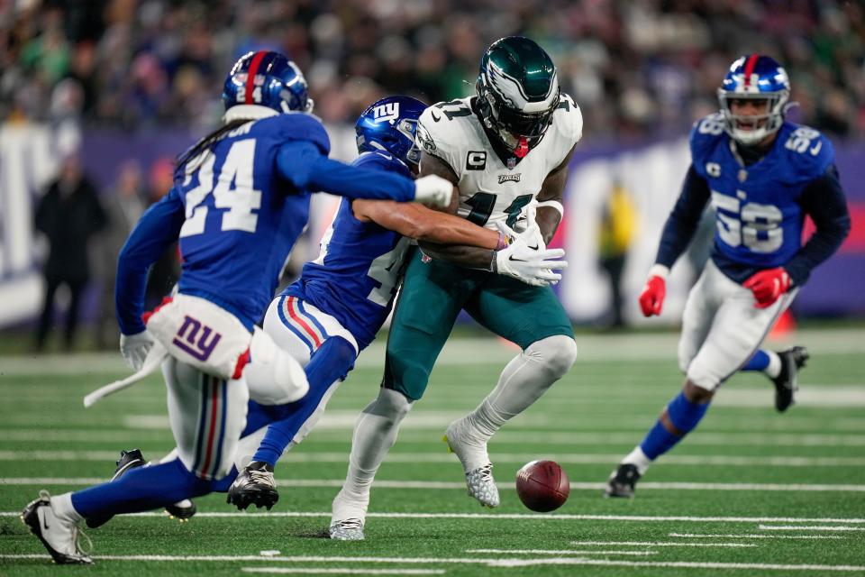 New York Giants cornerback Nick McCloud (44) forces a fumble on Philadelphia Eagles wide receiver A.J. Brown (11) during the first quarter of an NFL football game, Sunday, Jan. 7, 2024, in East Rutherford, N.J.