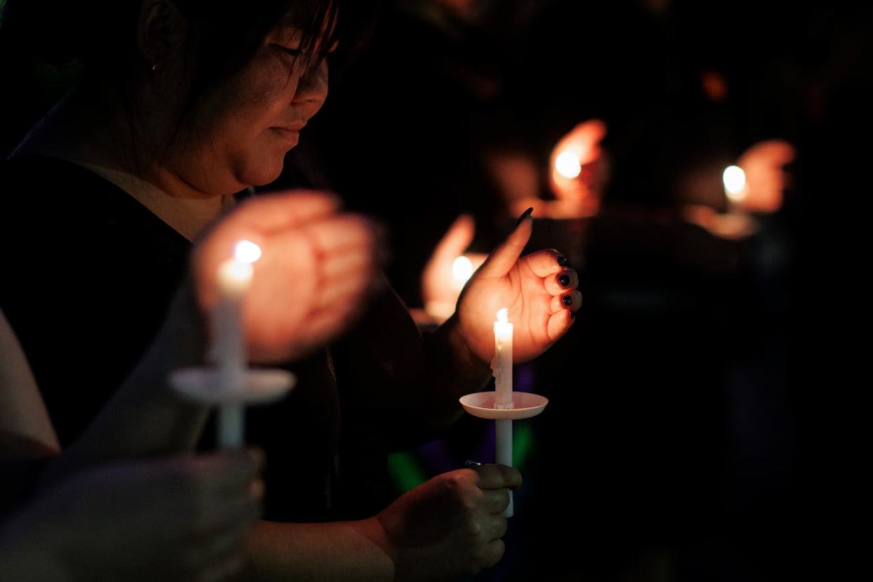 Community members take part in a candlelight vigil in downtown Saskatoon on Sept. 7, 2022. The gathering was held to remember the victims of a mass stabbing on James Smith Cree Nation and Weldon, Sask. (Evan Mitsui/CBC - image credit)