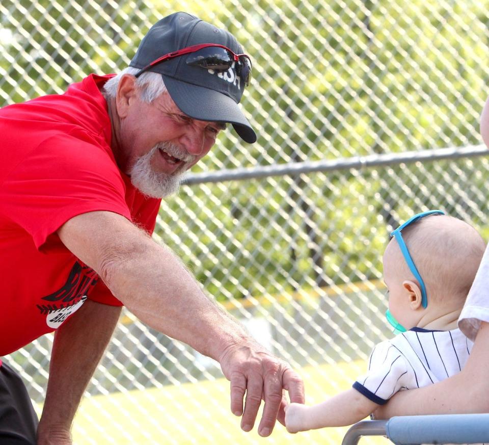 Ralph "Froggy" Poole greets a young softball fan at Murray Park Monday night.