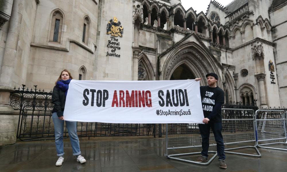 Campaigners hold a banner outside the high court in central London where the legality of UK arms exports to Saudi Arabia is under challenge. 