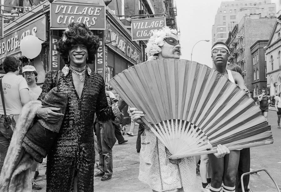 American gay liberation activist Marsha P. Johnson (1945 – 1992, center left, in dark outfit and black hair), along with unidentified others, on the corner of Christopher Street and 7th Avenue during the Pride March (later the LGBT Pride March), New York, New York, June 27, 1982. (Photo by Barbara Alper/Getty Images)