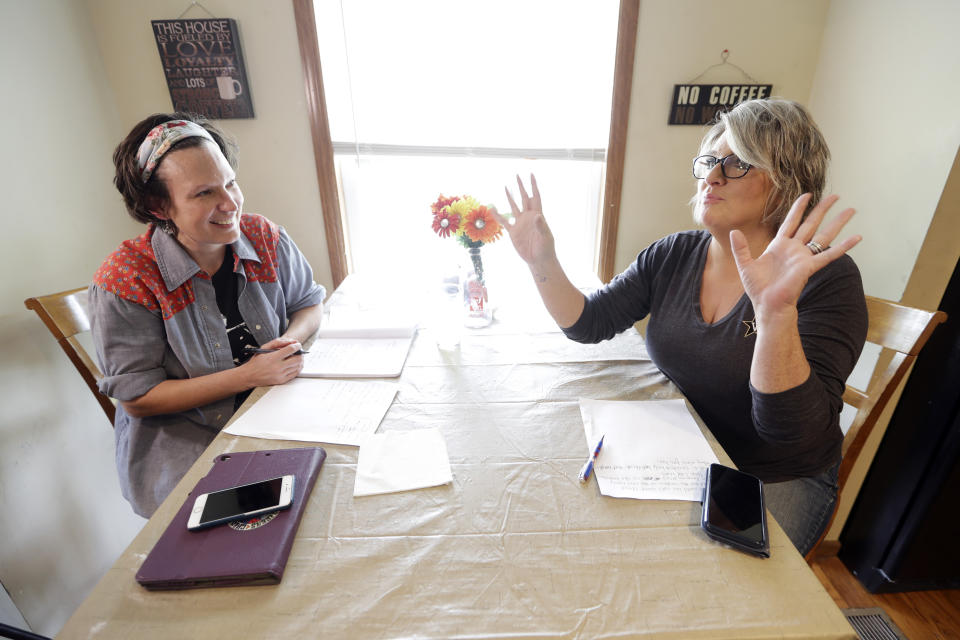 In this May 22, 2020, photo, nurse Megan Palmer, left and care partner Anna Henderson appear during a songwriting session at Henderson's home in Ashland City, Tenn. During the COVID-19 pandemic, their role as caregivers at Vanderbilt University Medical Center has become even more important as hospital visits from family and friends were limited or prohibited to prevent the spread of the virus. Music and songwriting has helped them express the complexity of emotions that comes with caregiving, especially in the time of a pandemic. (AP Photo/Mark Humphrey)