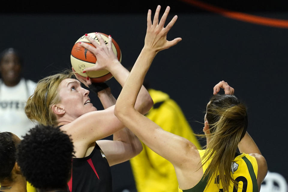 Las Vegas Aces center Carolyn Swords (4) shoots over Seattle Storm forward Breanna Stewart (30) during the first half of Game 1 of basketball's WNBA Finals Friday, Oct. 2, 2020, in Bradenton, Fla. (AP Photo/Chris O'Meara)