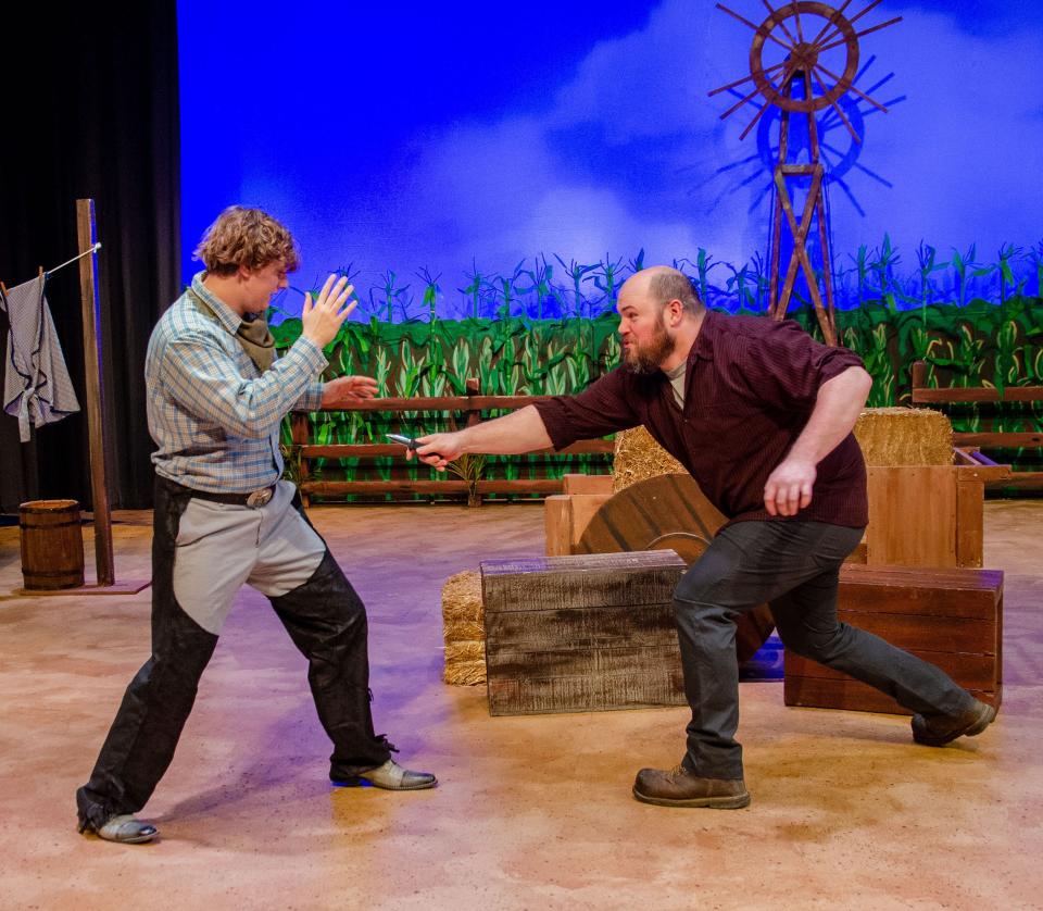Jud (Micah Harvey) pulls a knife on Curly during a rehearsal of "Oklahoma!" Carnation City Players will present the production this weekend and Feb. 23-25 at Firehouse Theater in downtown Alliance.