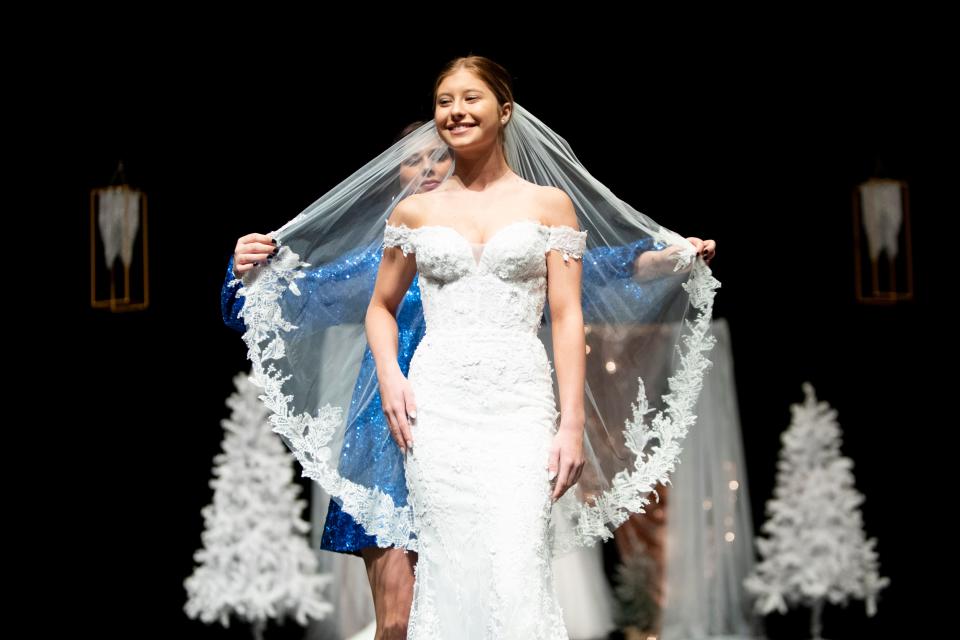 A model wears a dress from My Best Friend Jenna as a veil is added on during a fashion show portion of the Jackson Bridal Show at the Carl Perkins Civic Center on Sunday, January 8, 2023, in Jackson, Tenn. 
