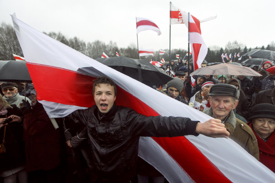 A prominent opponent of Belarus' authoritarian president Raman Pratasevich attends an opposition rally in Minsk, Belarus, Sunday, March 25, 2012. A prominent opponent of Belarus' authoritarian president has been arrested after the airliner in which he was traveling was diverted to the country after a bomb threat. The opposition and Western officials denounced the incident on Sunday, May 23, 2021 as a hijacking operation by the Belarus government. (AP Photo)