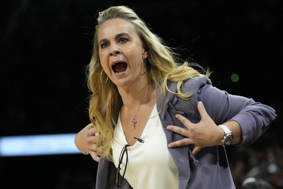 Las Vegas Aces head coach Becky Hammon motions towards the court during the second half in Game 2 of a WNBA basketball semifinal series against the Dallas Wings, Tuesday, Sept. 26, 2023, in Las Vegas. (AP Photo/John Locher)