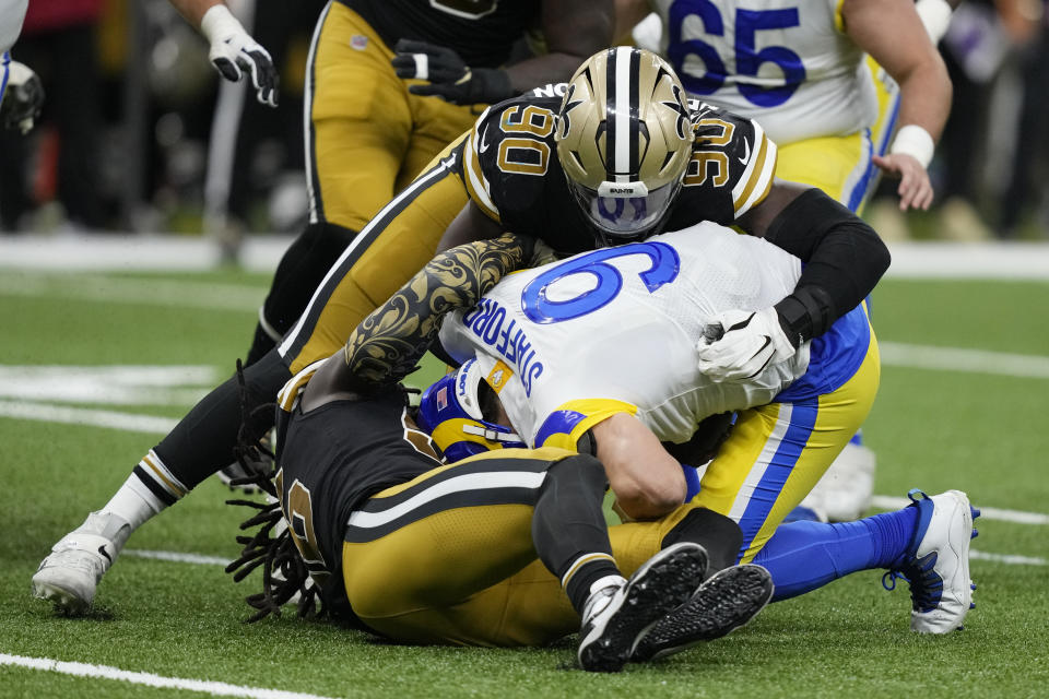 Los Angeles Rams quarterback Matthew Stafford (9) is sacked by New Orleans Saints defensive end Tanoh Kpassagnon (90) in the second half of an NFL football game in New Orleans, Sunday, Nov. 20, 2022. (AP Photo/Gerald Herbert)