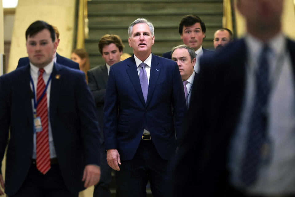 Kevin McCarthy walks through a hallway at the Capitol, flanked by staffers (Win McNamee / Getty Images file)
