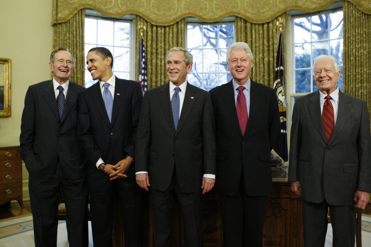 President-elect Barack Obama is welcomed from left, by former President George H. W. Bush for a meeting at the White House on Jan. 7, 2009, in Washington D.C., with from right, former Presidents Jimmy Carter and Bill Clinton; and President George W. Bush, center.